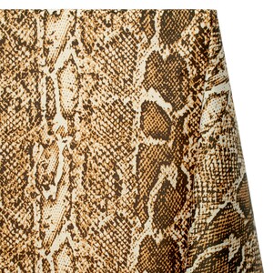 May include: Close-up of a brown and beige fabric with a snakeskin pattern.