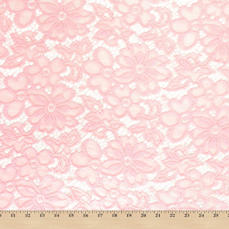 May include: Pink floral lace fabric with a delicate pattern. The lace is soft and sheer, and it would be perfect for a variety of projects, such as clothing, accessories, and home decor.