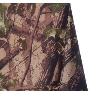May include: Camouflage fabric featuring a detailed pattern of tree bark, branches, and leaves in shades of brown, green, and tan. The fabric has a realistic woodland design, suitable for various crafting and sewing projects.