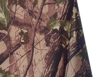 May include: Camouflage fabric featuring a detailed pattern of tree bark, branches, and leaves in shades of brown, green, and tan. The fabric has a realistic woodland design, suitable for various crafting and sewing projects.