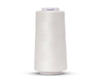 Può includere: Un'bobina di filo bianco con la scritta "keedll" stampata sull'etichetta.