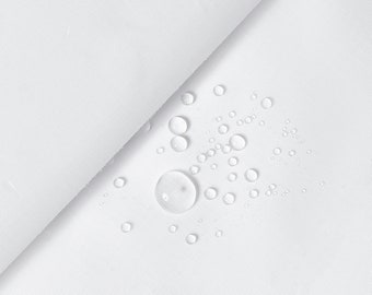 May include: White fabric with multiple water droplets on the surface. The fabric is smooth and appears to be waterproof.