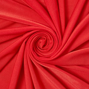May include: A close-up of a red fabric swirled into a spiral shape, creating a textured, abstract design.