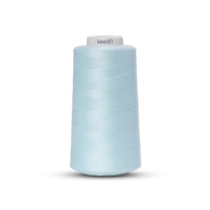 May include: A spool of light blue sewing thread with the brand name "keedll" printed on the label.