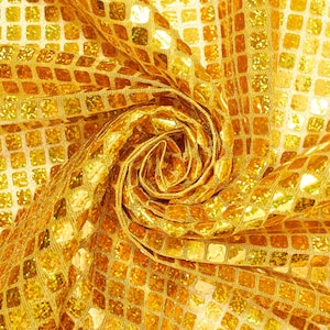 May include: Gold fabric with a square pattern. The fabric is folded and twisted to create a swirling, rose-like shape.