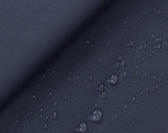 May include: Close-up of a dark blue fabric with water droplets on the surface. The fabric has a subtle texture.
