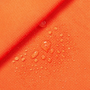 May include: Orange fabric with water droplets on the surface. The fabric is textured and has a slight sheen.