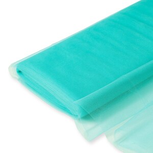 May include: A roll of turquoise tulle fabric. The fabric is soft and sheer, with a delicate texture.
