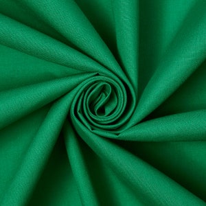 May include: A close-up shot of a vibrant green fabric, tightly swirled to create a spiral effect. The fabric appears to be a solid color, with a smooth texture and a slight sheen. The folds and curves of the fabric create shadows and highlights.