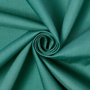 May include: A close-up of teal fabric folded and twisted into a spiral shape. The fabric is smooth and has a subtle sheen.