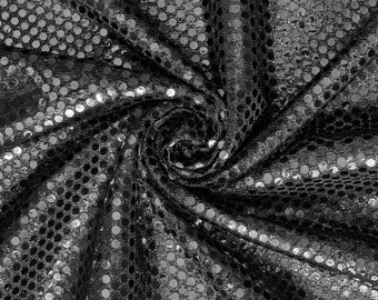 May include: Black fabric with silver sequins in a circular pattern. The fabric is gathered and twisted, creating a swirling effect.