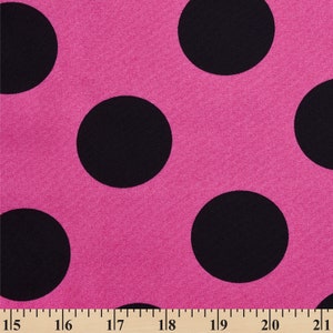 May include: Pink fabric with black polka dots. The fabric is textured and has a subtle sheen.