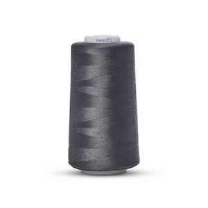 May include: A spool of dark gray sewing thread with the word "keedli" printed on the label.