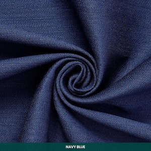 May include: Close-up of navy blue fabric with a swirling pattern. The fabric is a deep shade of blue, with visible texture and folds. The text "NAVY BLUE" is at the bottom of the image.