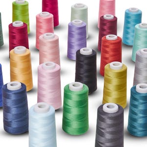 May include: A collection of colorful thread spools in various shades, including pink, green, blue, and yellow. The spools are arranged closely together, showcasing a variety of colors and textures. The thread is wound around a white core.