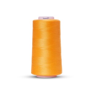 May include: A spool of bright orange thread with the word "keedll" printed on the label.