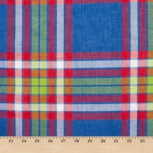 May include: Red, blue, green, and white plaid fabric with a woven texture. The fabric is measured with a ruler in inches.