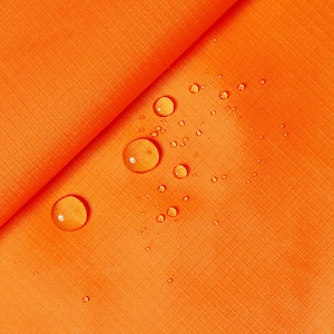 May include: Orange fabric with water droplets on the surface. The fabric has a subtle texture and is waterproof.