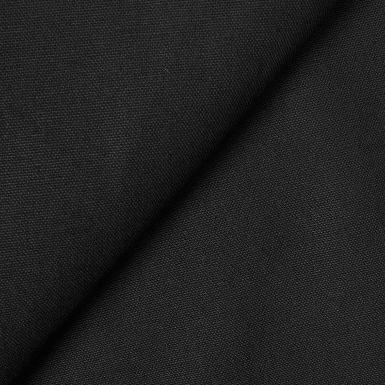 May include: Close-up of a black fabric with a woven texture.
