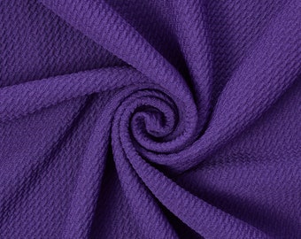 May include: Purple textured fabric with a swirling pattern.