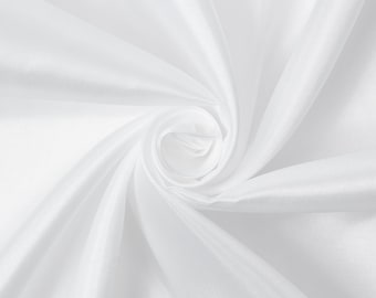 May include: White fabric with a smooth, silky texture, draped and folded to create a swirling pattern.