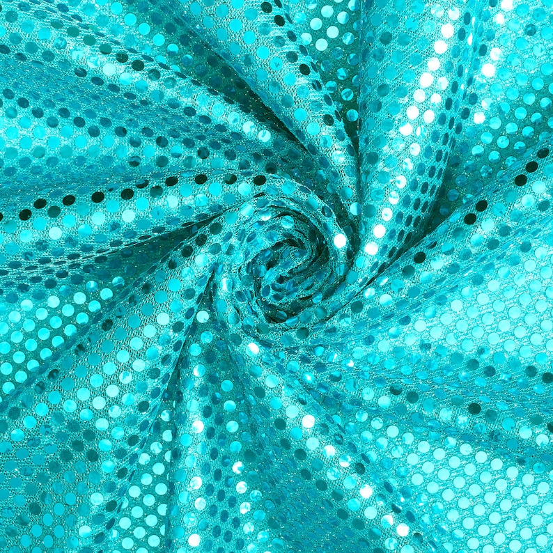 May include: Turquoise fabric with a swirling pattern of sequins. The fabric is shiny and has a metallic sheen.