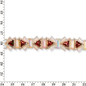 May include: A close-up of a decorative trim with a repeating pattern of red and iridescent white geometric shapes. The trim is approximately 1.75 inches wide.