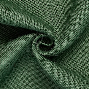 May include: Close-up of a green burlap fabric with a rough texture. The fabric is folded and twisted, showing the weave of the material.