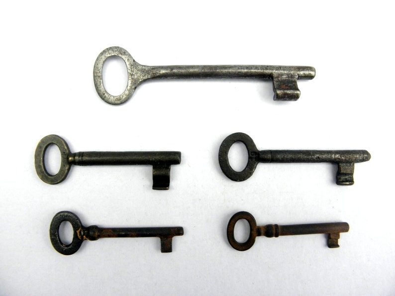 May include: Five antique keys with different shapes and sizes. The keys are made of metal and have a worn, aged appearance.