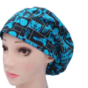 May include: A blue and black scrub hat with a pattern of x-ray images of bones and skulls.