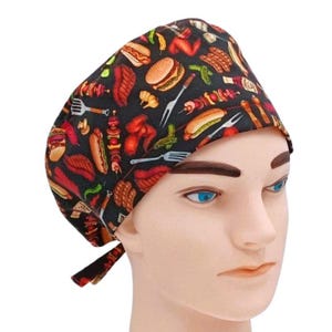 May include: A black scrub hat with a colorful print of various barbecue foods, including hot dogs, hamburgers, and chicken.