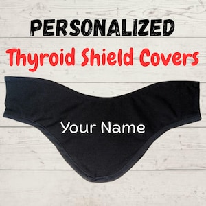 May include: Black cotton thyroid shield cover with a white embroidered "Your Name" on the front. Personalized thyroid shield covers.