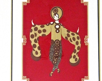May include: A framed print of a woman in a gold and brown patterned dress with a red background. The woman is standing with her arms outstretched and has a large, round headpiece. The print is surrounded by a gold frame.