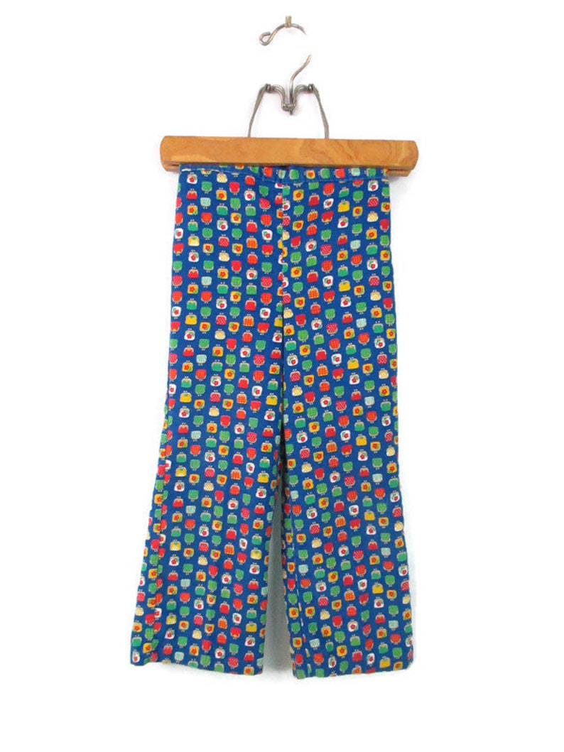 May include: Blue pants with a colorful geometric pattern. The pattern features small squares with red, yellow, green, and white accents.