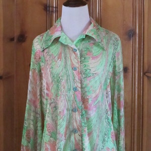 May include: A long-sleeved, green, pink, and white patterned shirt with a button-up front.