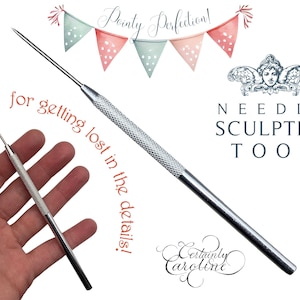 May include: Two silver needle sculpting tools with a textured handle. The tools are held in a hand. The text "Pointy Perfection!" and "for getting lost in the details!" is written in red. The text "NEEDLE SCULPTING TOOL" is written in black. The text "Certainly Caroline" is written in black cursive.