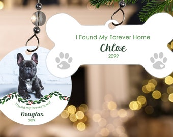 May include: Two personalized dog bone Christmas ornaments. One ornament features a photo of a black French Bulldog with the text "I found my forever home Douglas 2022". The other ornament is white with the text "I Found My Forever Home Chloe 2022".