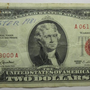May include: A vintage two-dollar bill featuring a portrait of Thomas Jefferson. The bill has a green and black border with the text "TWO DOLLARS" repeated. The bill is marked with the text "Dr. Easter 1981" in blue ink.
