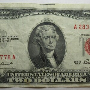 May include: A two dollar bill with a portrait of Thomas Jefferson. The bill is dated 1969 and has the serial number A 28388778 A. The bill is in good condition.