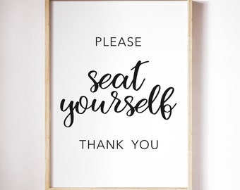 May include: A framed print with the text "PLEASE seat yourself THANK YOU" in black cursive font on a white background.