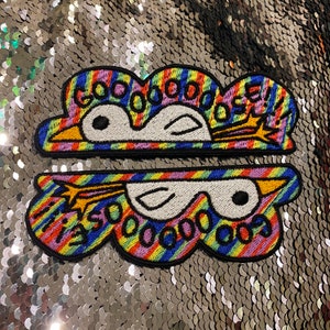 May include: Two embroidered patches featuring a cartoon penguin design. The patches are cloud-shaped with rainbow stripes and the text "GOOOOOOSE!!!" and "I'M SOOOOOO GOOSE". The penguin has white eyes and a yellow beak.