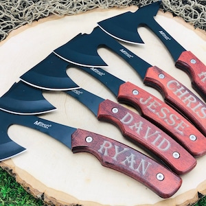 May include: Five personalized small axes with black blades and wooden handles. The handles are engraved with the names "Ryan", "David", "Jesse", "Chris", and "Rob".