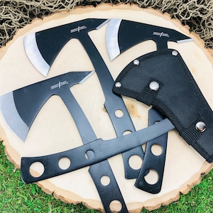 May include: Four black throwing axes with a black nylon sheath. The axes have a silver blade and the text "THROWING AXE" is printed on the handle.