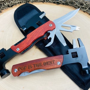 May include: Two multi-tool wrenches with wooden handles and black metal components. One has a blade and other tools, the other has the text "POP IS THE BEST" engraved on the handle. Both are in a black carrying case.
