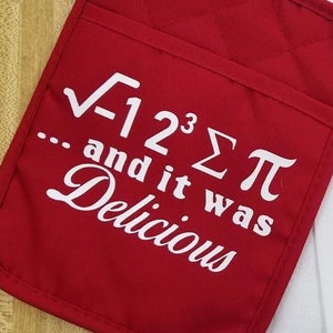 May include: Red quilted oven mitt with a white graphic that says "√-12³Σπ... and it was Delicious".
