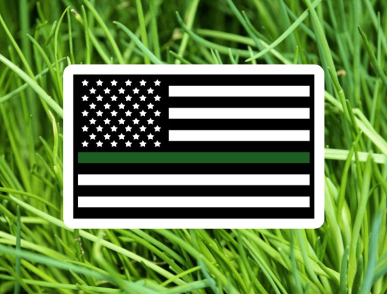 May include: A thin green line is added to the American flag, representing support for law enforcement.