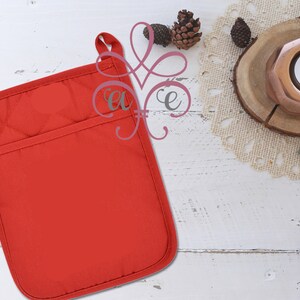 May include: Red quilted oven mitt with a pocket on the front. The mitt is on a white wooden surface.