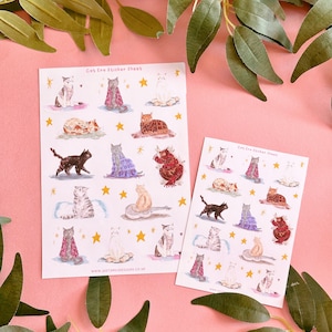May include: Two sheets of stickers featuring watercolor illustrations of cats in various poses. The stickers are on a pink background. The text on the stickers reads "Cat Era Sticker Sheet" and "www.justsmiledesigns.co.uk".