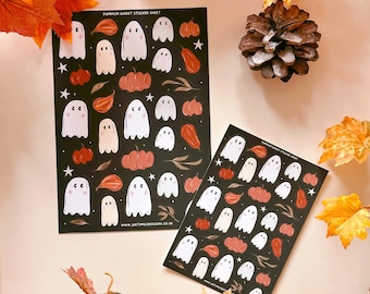 May include: Two sticker sheets with a black background and white ghosts, orange pumpkins, and brown leaves. The text on the sticker sheet reads "Pumpkin Ghost Sticker Sheet" and "www.justemiledesign.co.uk".