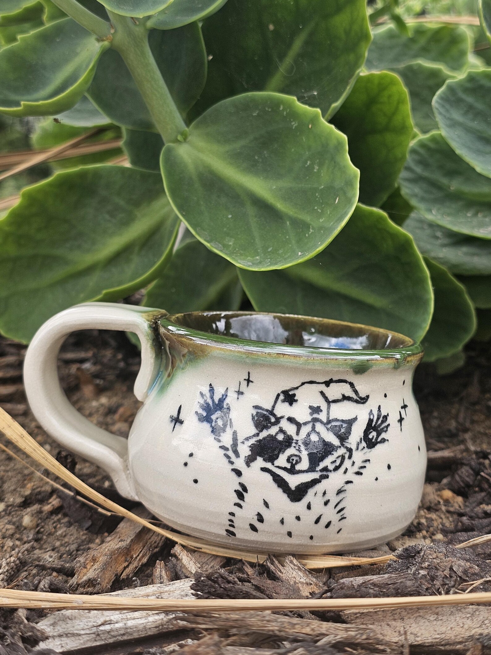 Handmade ceramic mug featuring Wizard Raccoon